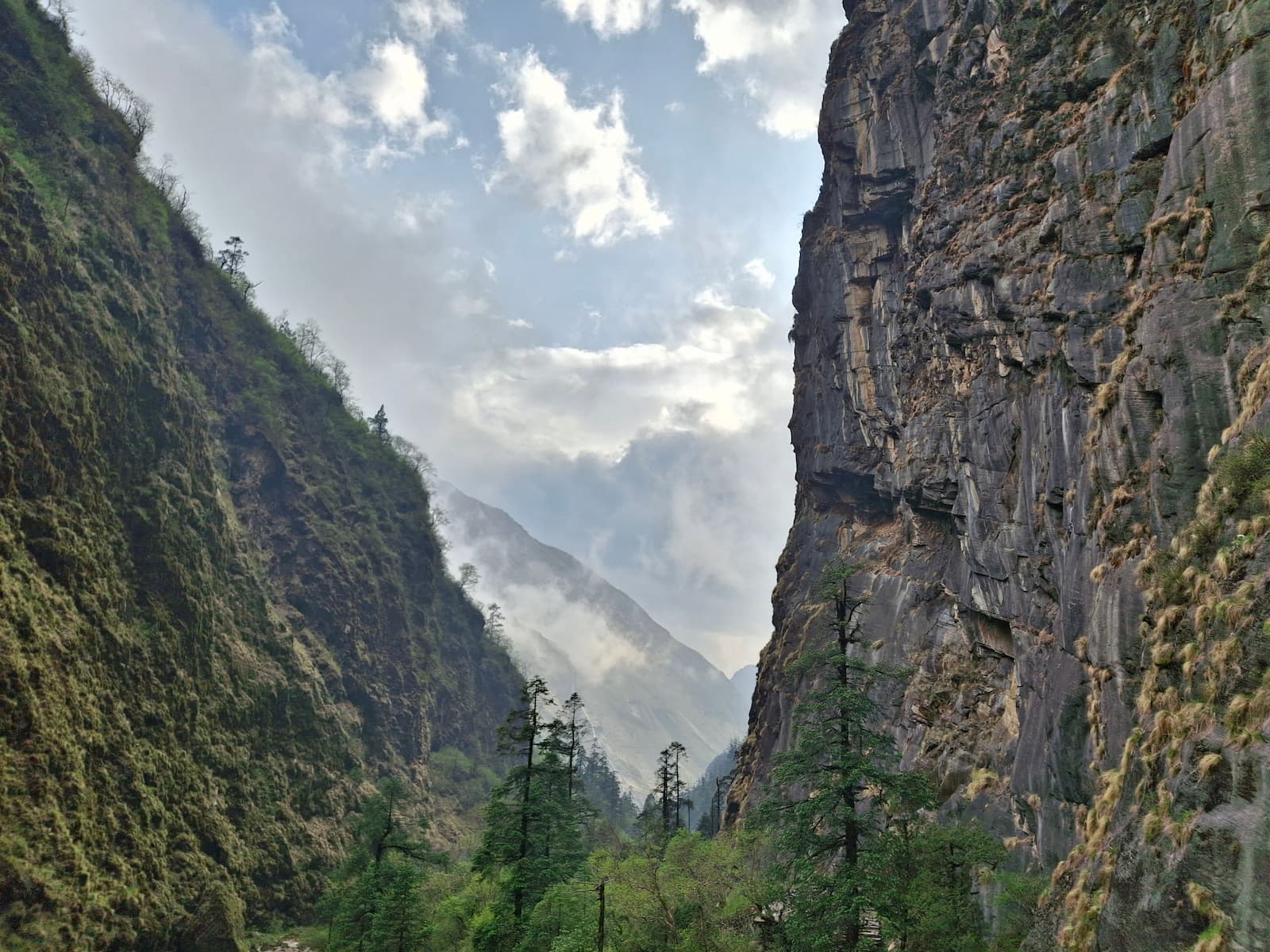 Panoramic view over the deep Himalayan mountain valley and rolling ridgelines