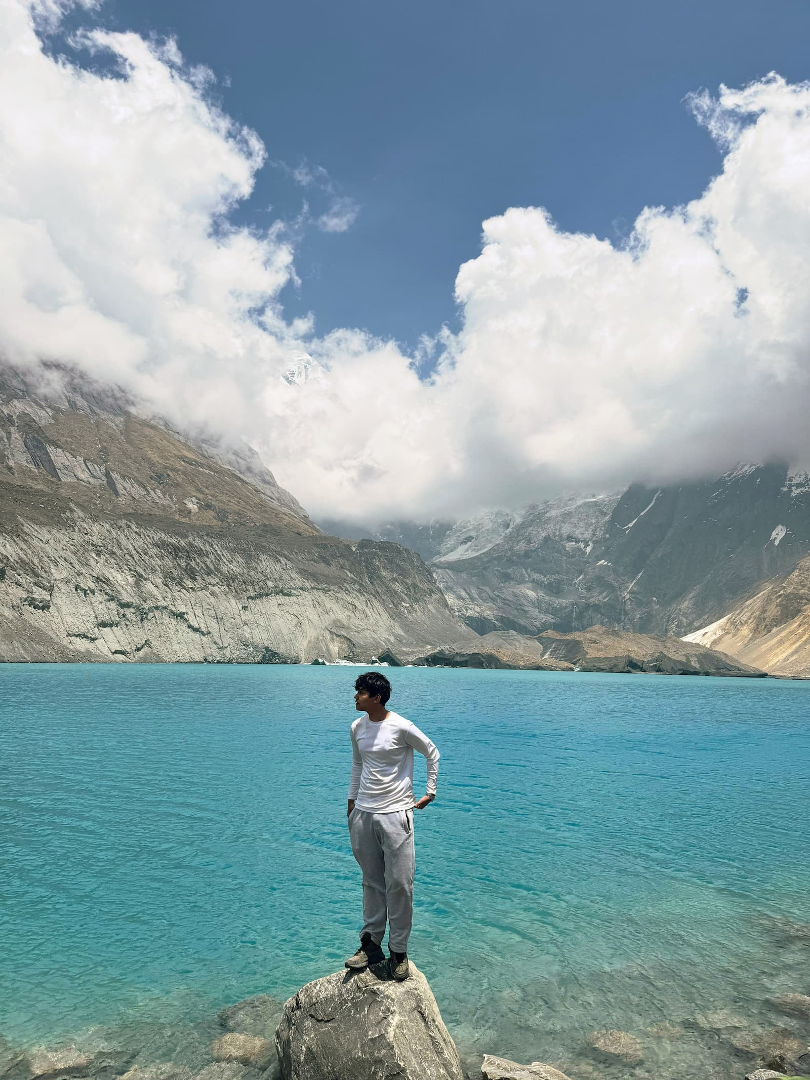 High alpine turquoise lake nestled beneath rugged Himalayan peaks at Annapurna North Base Camp